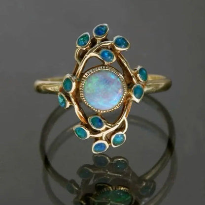 Anillo retro azul con cristales y ópalo