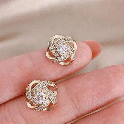 Aretes en forma de cruz con motivo floral