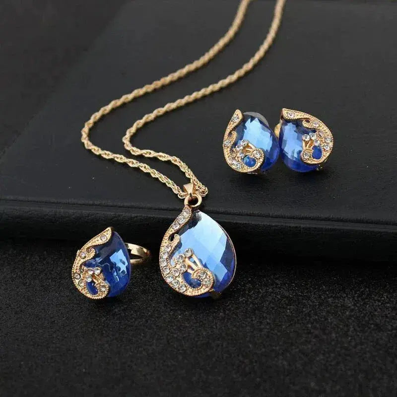 Conjunto de collar y aretes de cristal azul con dorado